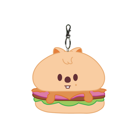 Keychain shaped like a cartoonish burger with a face on a white background